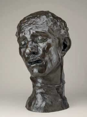 Sculpture of a woman's head and neck with closed eyes and a serene expression.